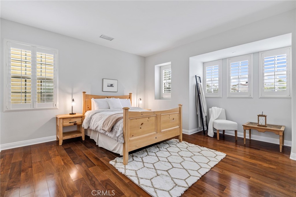 12 John Street Ladera Ranch, CA 92694 - Photo 24 of 37 a bedroom with a bed and wooden floor