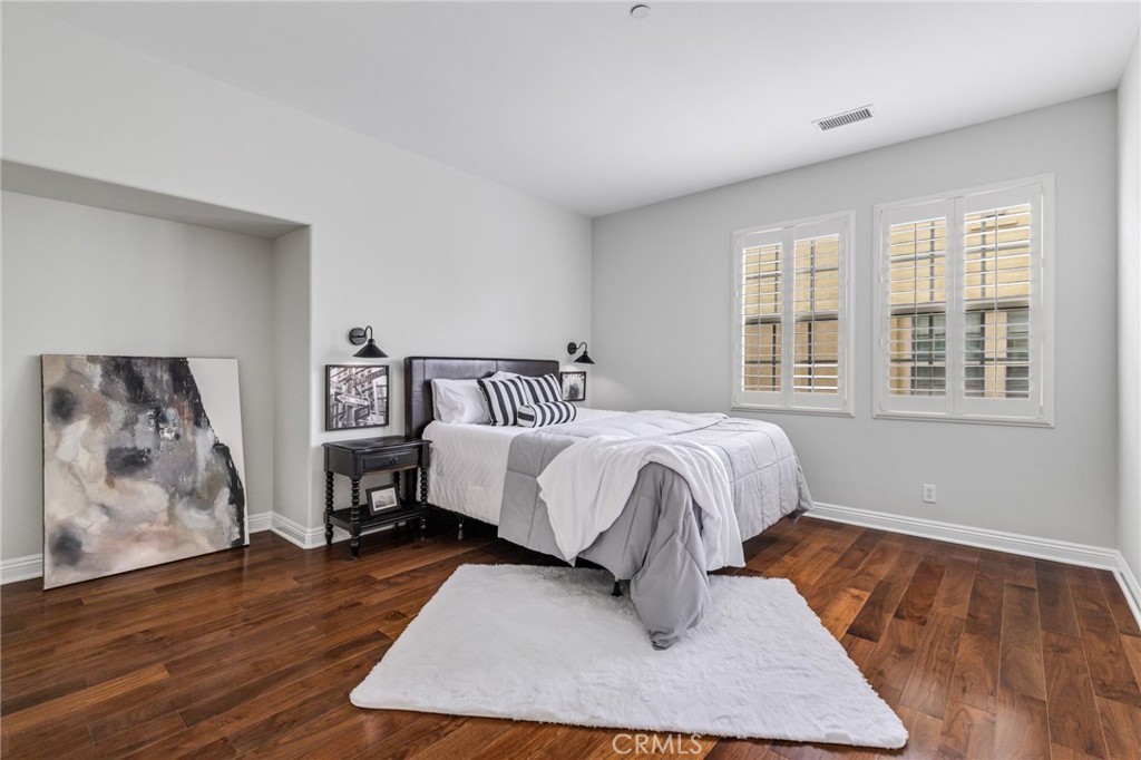 12 John Street Ladera Ranch, CA 92694 - Photo 27 of 37 a bedroom with a bed and wooden floor