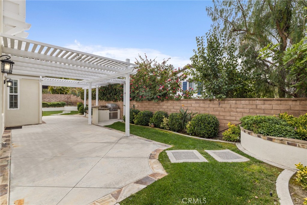 12 John Street Ladera Ranch, CA 92694 - Photo 32 of 37 a view of a patio with table and chairs potted plants with wooden fence
