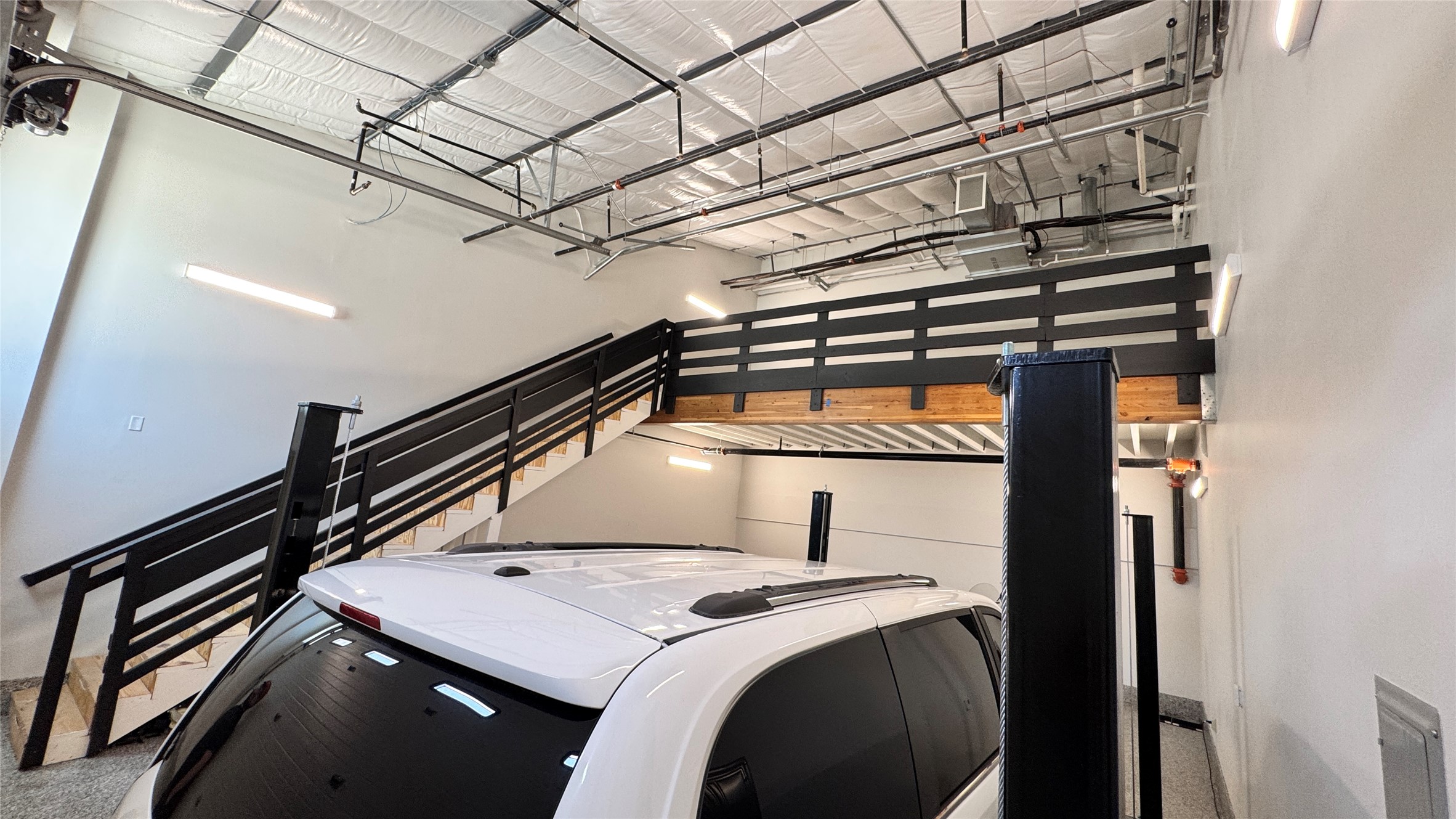 1009 Ranch Road 620 North, Unit 401 Lakeway, TX 78734 - Photo 4 of 15 High ceilings and an upper-level mezzanine offer versatile space, complemented by a convenient interior staircase.