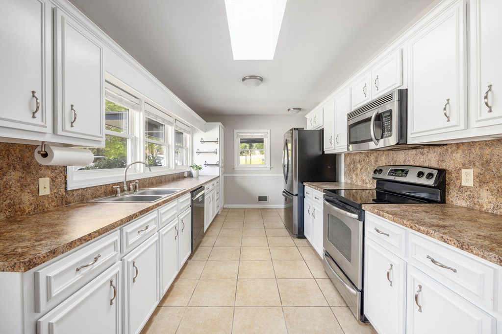 6366 Michael Avenue Columbus, GA 31909 - Photo 13 of 38 a large kitchen with stainless steel appliances granite countertop a stove a sink and a granite counter tops