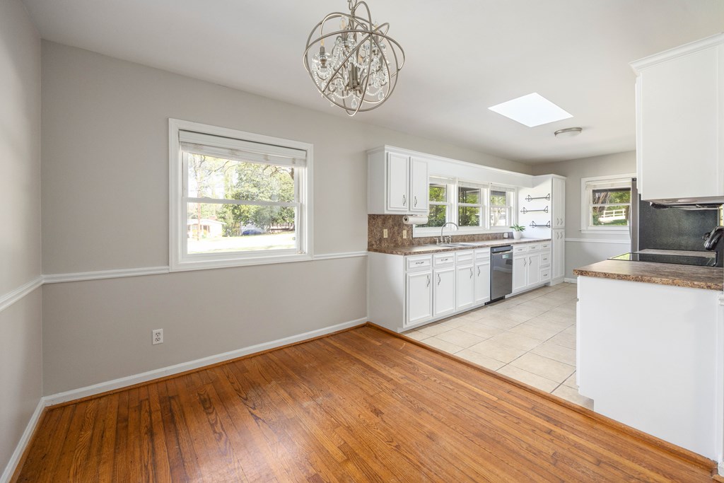 6366 Michael Avenue Columbus, GA 31909 - Photo 16 of 38 a kitchen with stainless steel appliances granite countertop a stove and a wooden floors