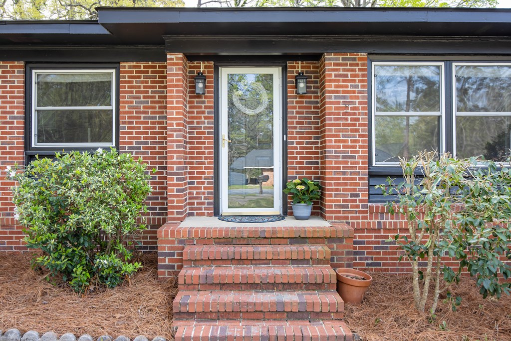 6366 Michael Avenue Columbus, GA 31909 - Photo 7 of 38 a front view of a house with a garden
