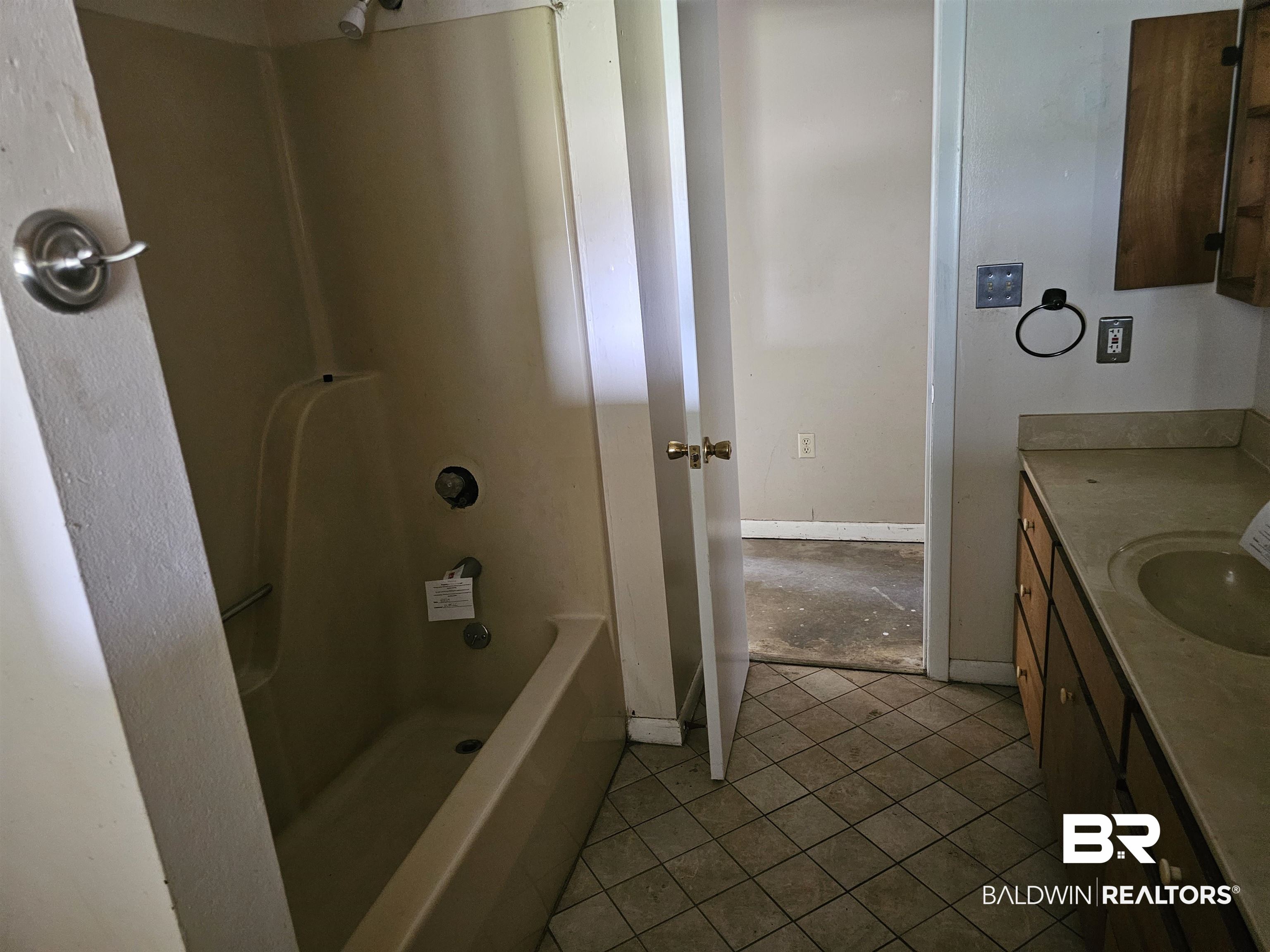 59575 Lottie Road Atmore, AL 36502 - Photo 23 of 23 Full bath featuring tile patterned flooring, shower / tub combination, baseboards, and vanity