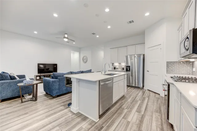 a large kitchen with stainless steel appliances granite countertop a large center island and a stove