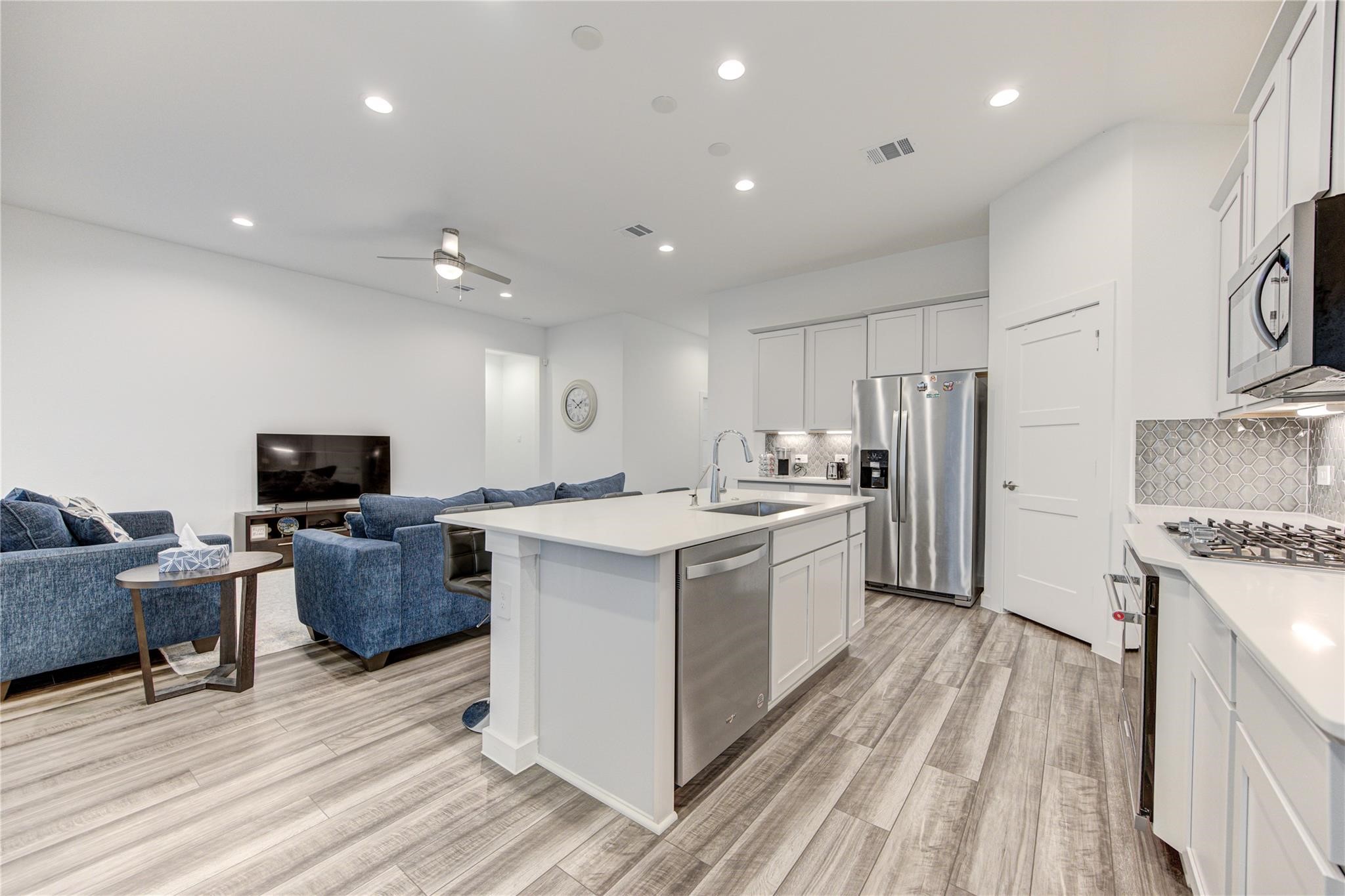 22515 Modica Rift Lane Katy, TX 77449 - Photo 20 of 34 a large kitchen with stainless steel appliances granite countertop a large center island and a stove