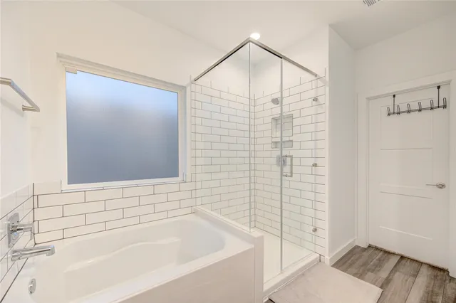 a bathroom with a bathtub and shower