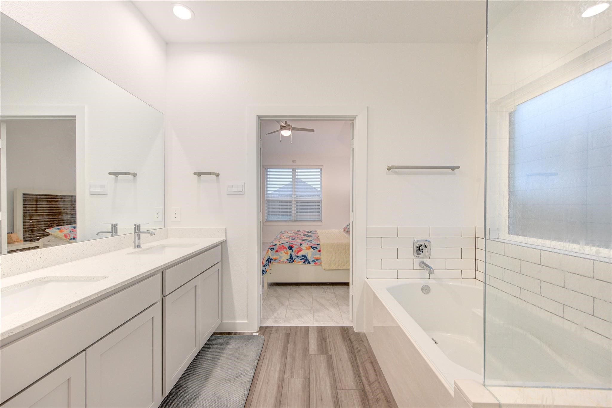 22515 Modica Rift Lane Katy, TX 77449 - Photo 28 of 34 a spacious bathroom with a tub sink and mirror