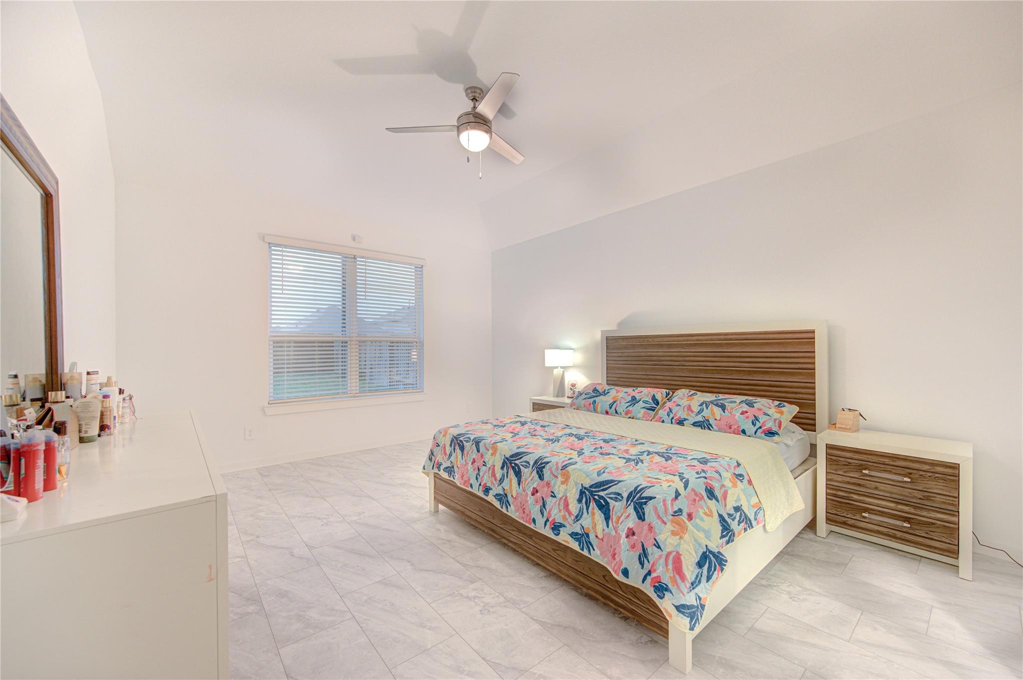 22515 Modica Rift Lane Katy, TX 77449 - Photo 30 of 34 a bedroom with a bed and a chandelier