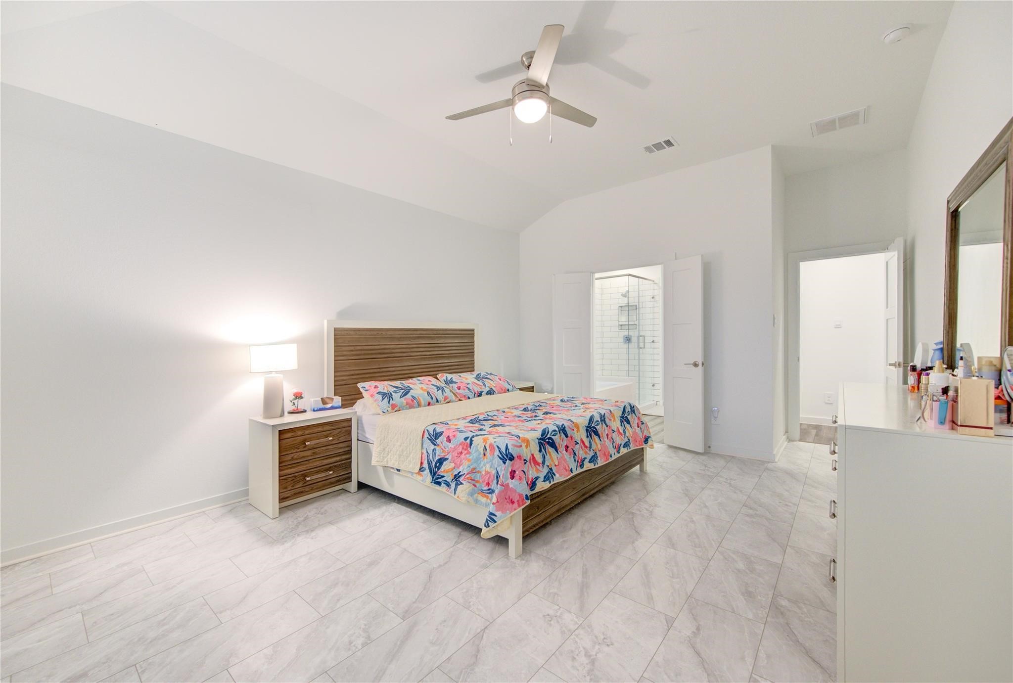 22515 Modica Rift Lane Katy, TX 77449 - Photo 31 of 34 a bedroom with a bed and a chandelier