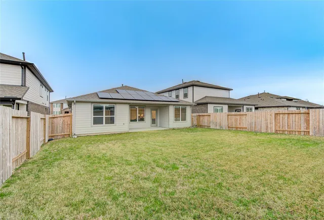a big white house with a big yard and large trees