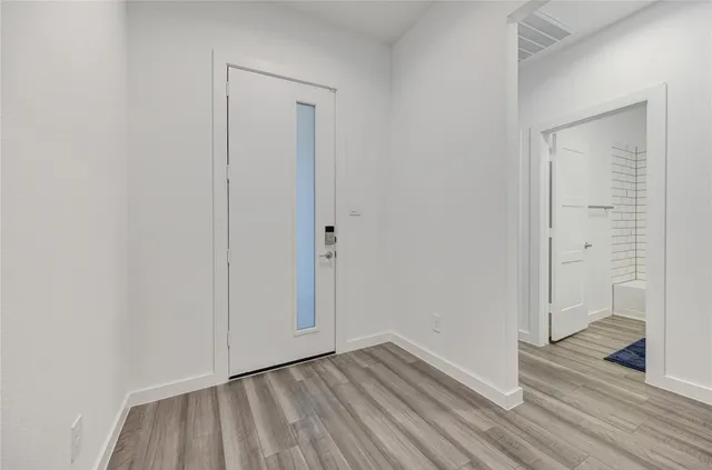 a view of an empty room and wooden floor