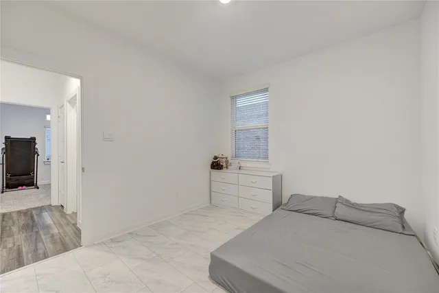 a bedroom with a bed and a television