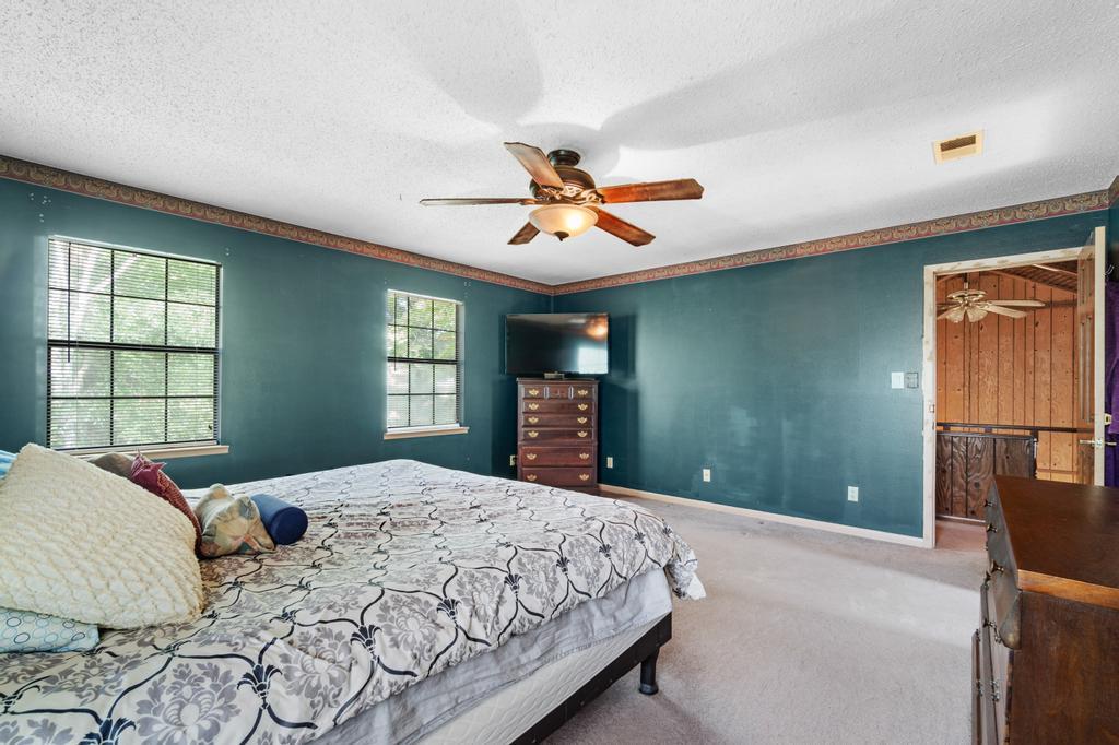 710 Ridge Lake Road Crestview, FL 32536 - Photo 13 of 43 a bedroom with a large bed and a chandelier