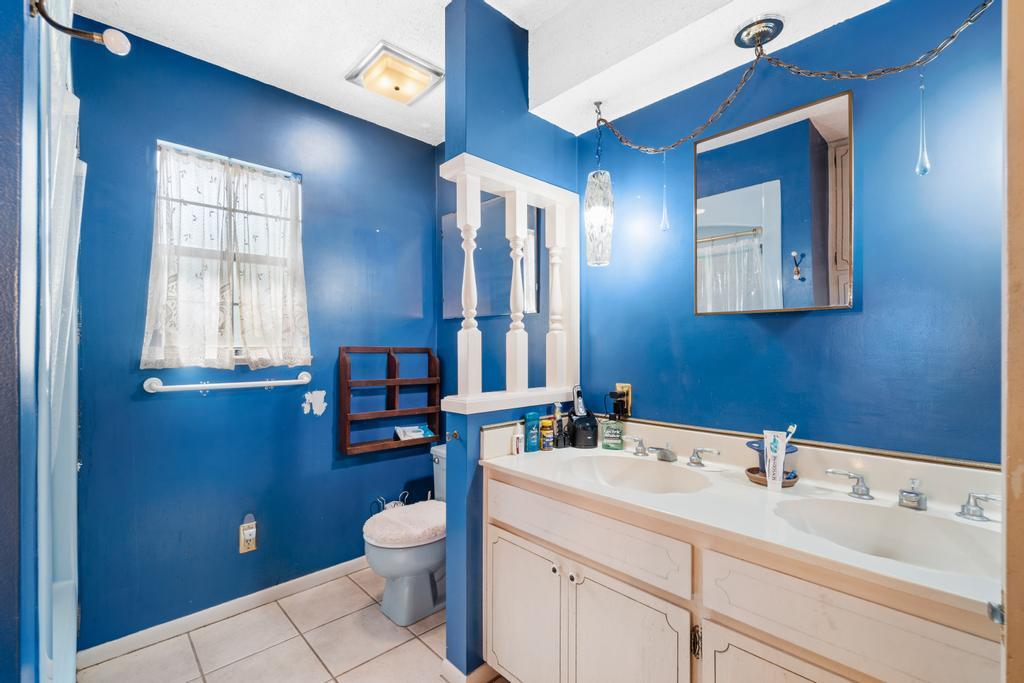 710 Ridge Lake Road Crestview, FL 32536 - Photo 15 of 43 a bathroom with a toilet sink and mirror