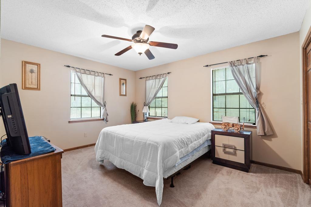710 Ridge Lake Road Crestview, FL 32536 - Photo 18 of 43 a bedroom with a bed a window and dresser