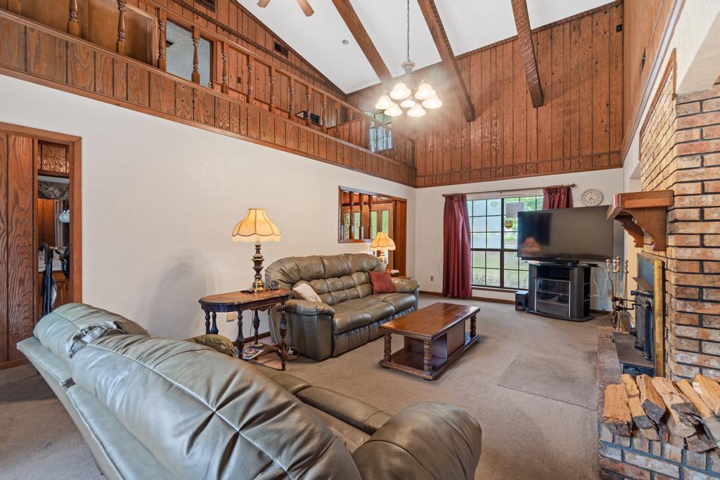 710 Ridge Lake Road Crestview, FL 32536 - Photo 3 of 43 a living room with furniture a fireplace and a large window