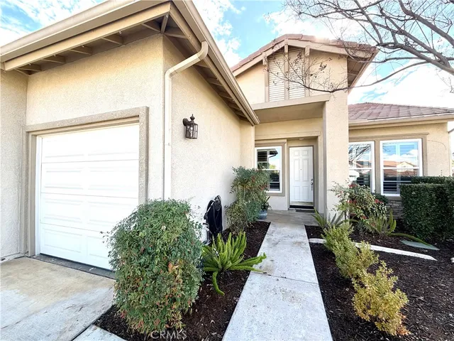 a view of a house with garden and plants