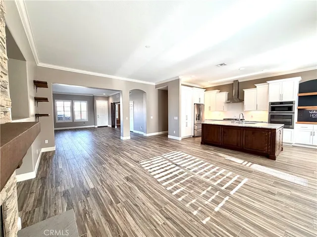 a view of kitchen and hall with wooden floor