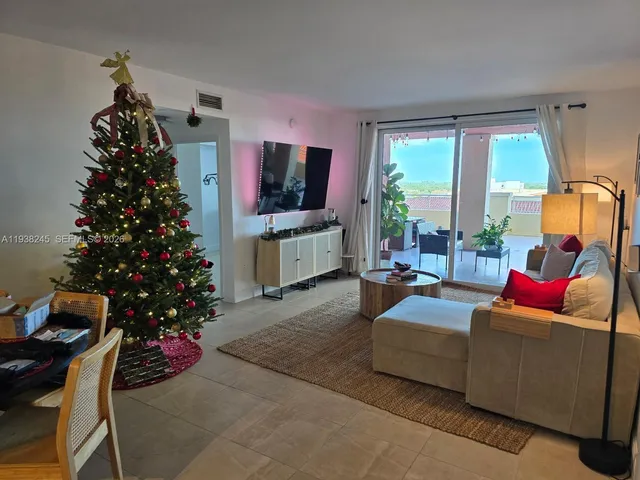 a living room with furniture and a christmas tree