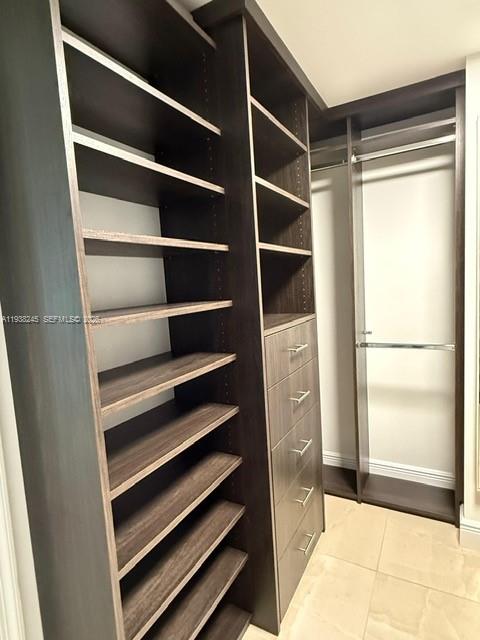 7350 Southwest 89th Street, Unit 907S Miami, FL 33156 - Photo 13 of 25 a view of walk in closet with empty racks