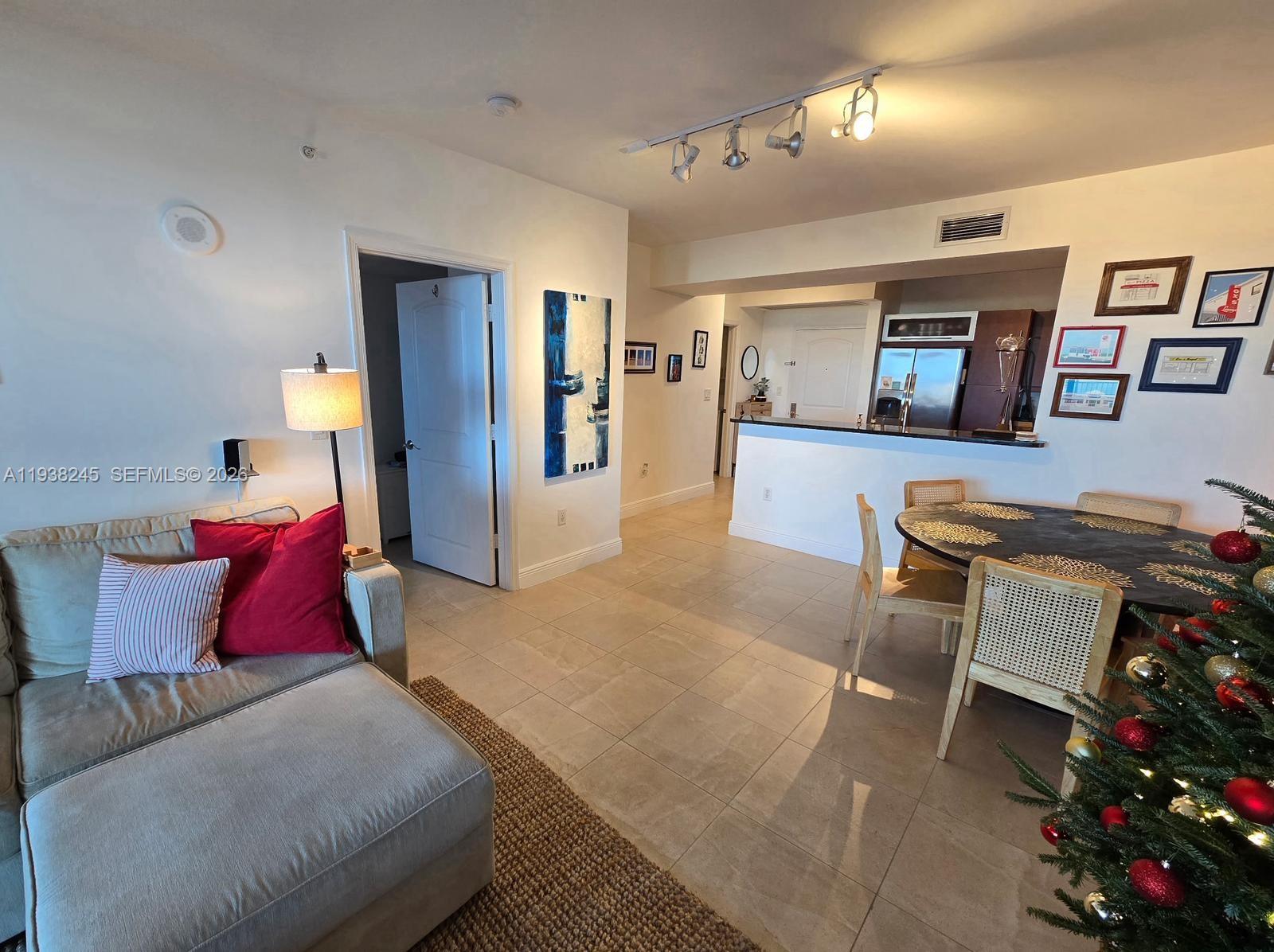 7350 Southwest 89th Street, Unit 907S Miami, FL 33156 - Photo 13 of 19 a living room with furniture and a couch