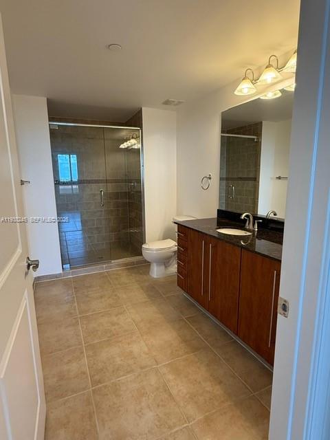 7350 Southwest 89th Street, Unit 907S Miami, FL 33156 - Photo 16 of 25 a bathroom with a sink a toilet and mirror