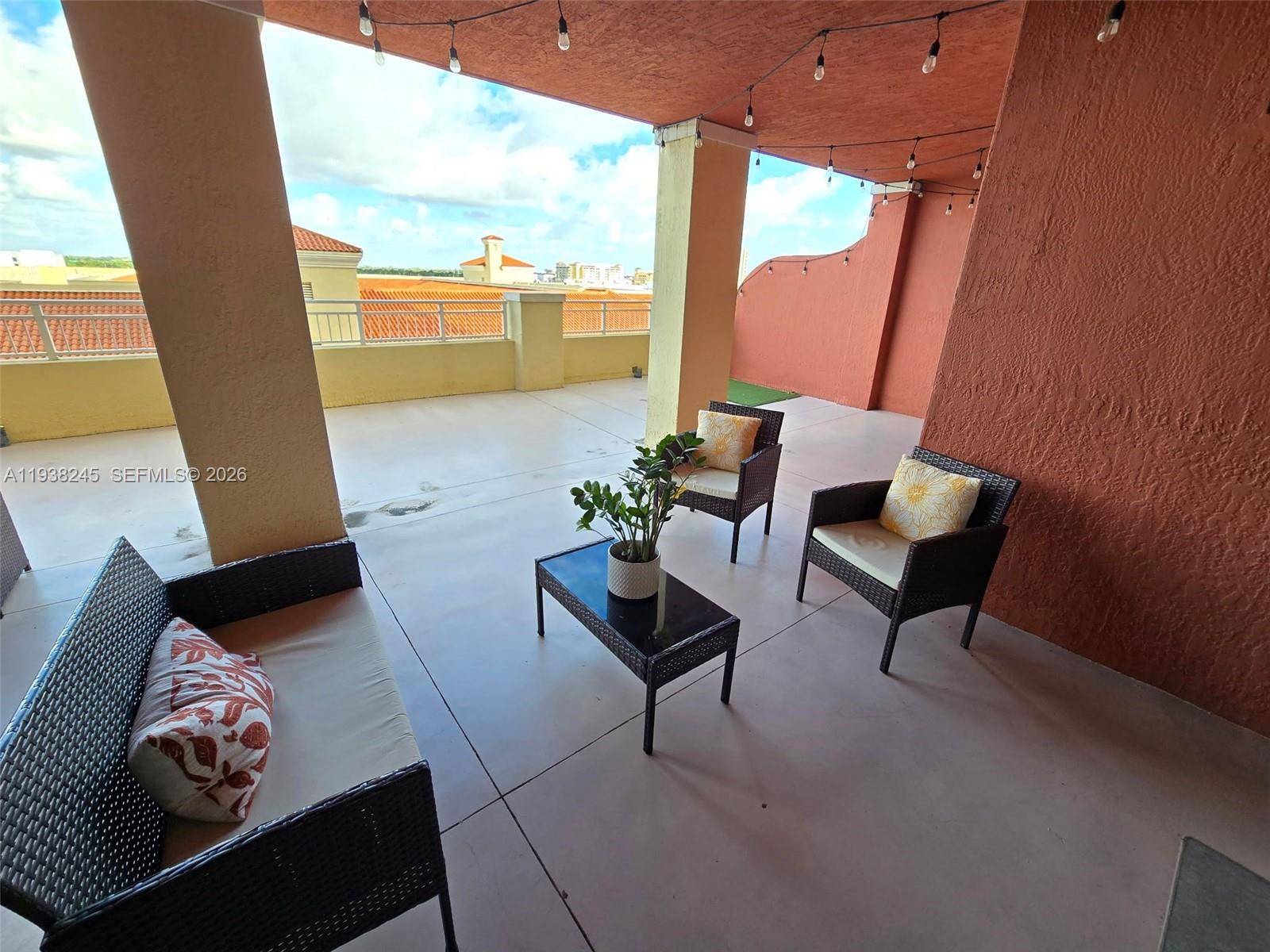 7350 Southwest 89th Street, Unit 907S Miami, FL 33156 - Photo 18 of 19 a living room with furniture and a floor to ceiling window