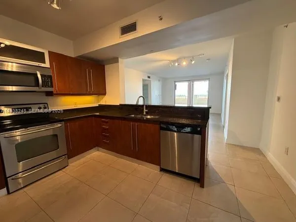 a kitchen with a sink and a stove top oven