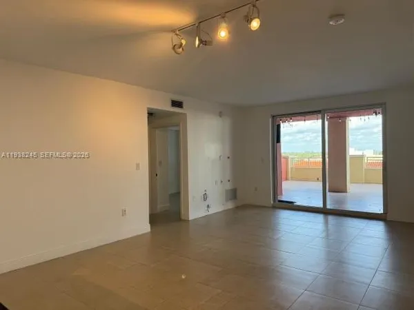 a view of an empty room with a window