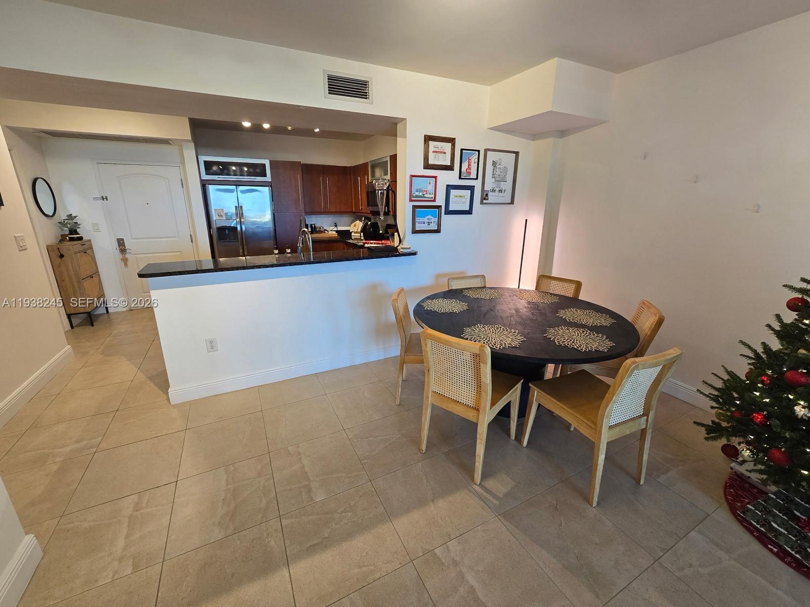 7350 Southwest 89th Street, Unit 907S Miami, FL 33156 - Photo 9 of 19 a living room with furniture and a wooden floor