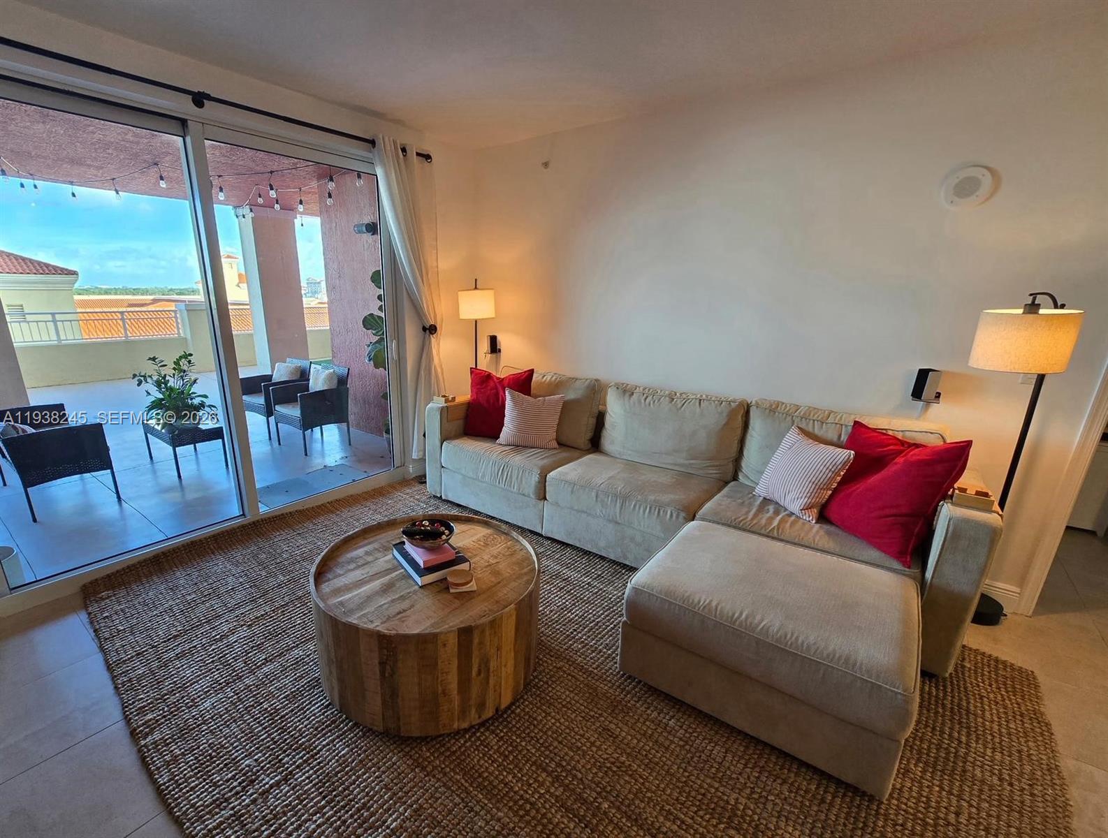 7350 Southwest 89th Street, Unit 907S Miami, FL 33156 - Photo 10 of 19 a living room with furniture and a large window