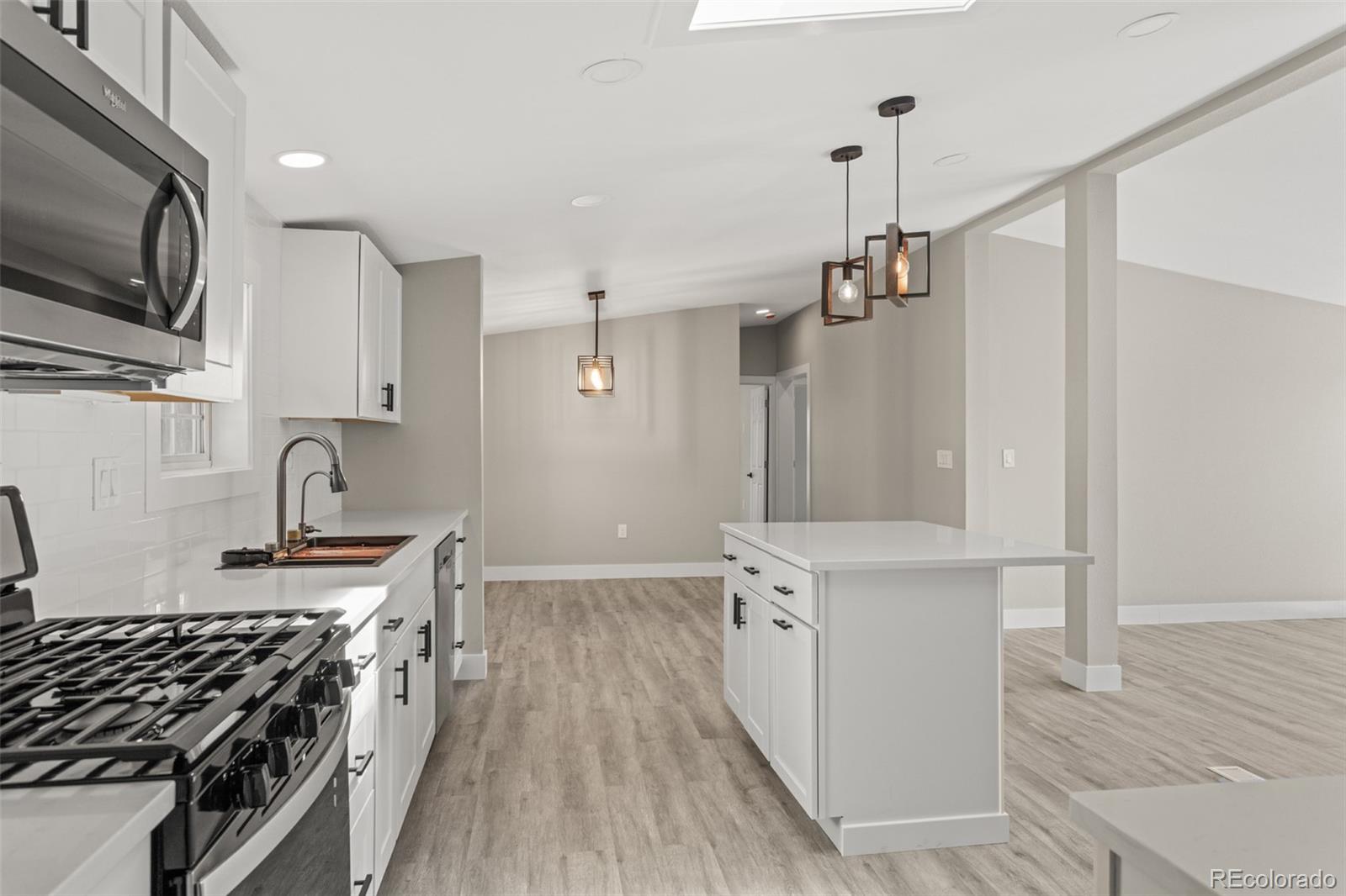 661 South Raleigh Street Denver, CO 80219 - Photo 4 of 19 a kitchen with stainless steel appliances granite countertop a stove and a sink