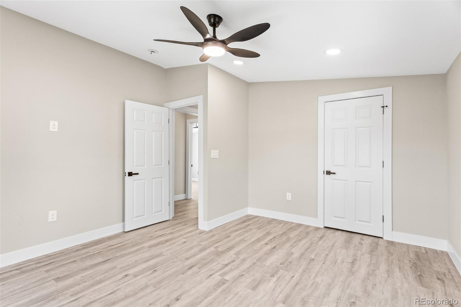 661 South Raleigh Street Denver, CO 80219 - Photo 8 of 19 an empty room with wooden floor and a ceiling fan