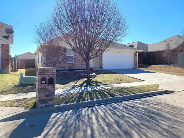 a view of a backyard with wooden fence
