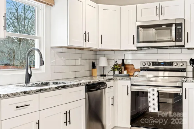 a kitchen with a stove and cabinets