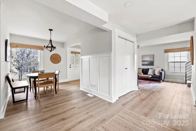 a view of a dining room with furniture and wooden floor