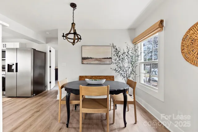 a bedroom with a bed a window and a chandelier