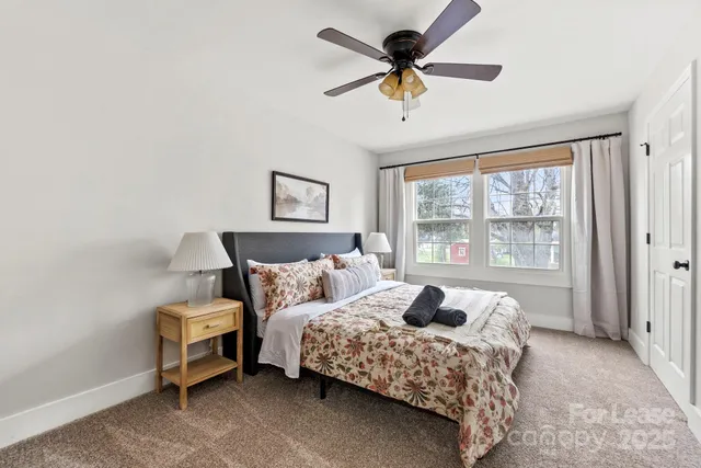 a bathroom with a granite countertop sink a toilet and a mirror