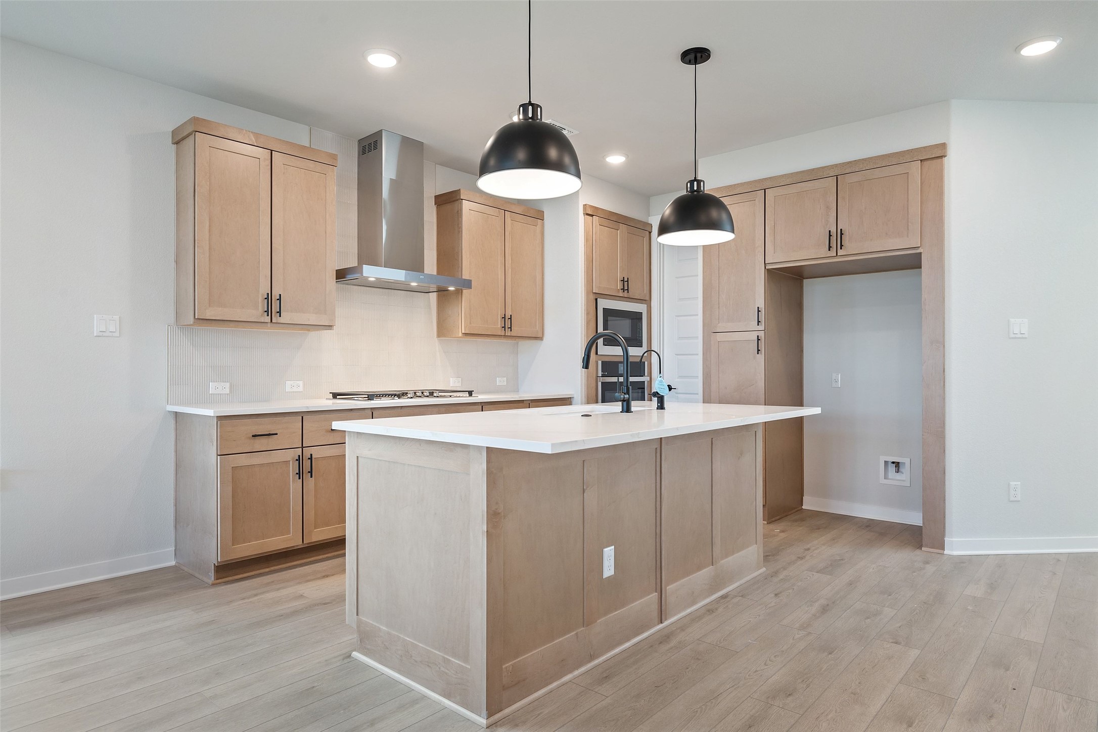 228 Brandywine Road Hutto, TX 78634 - Photo 12 of 40 a kitchen with kitchen island granite countertop a stove a sink a center island and cabinets