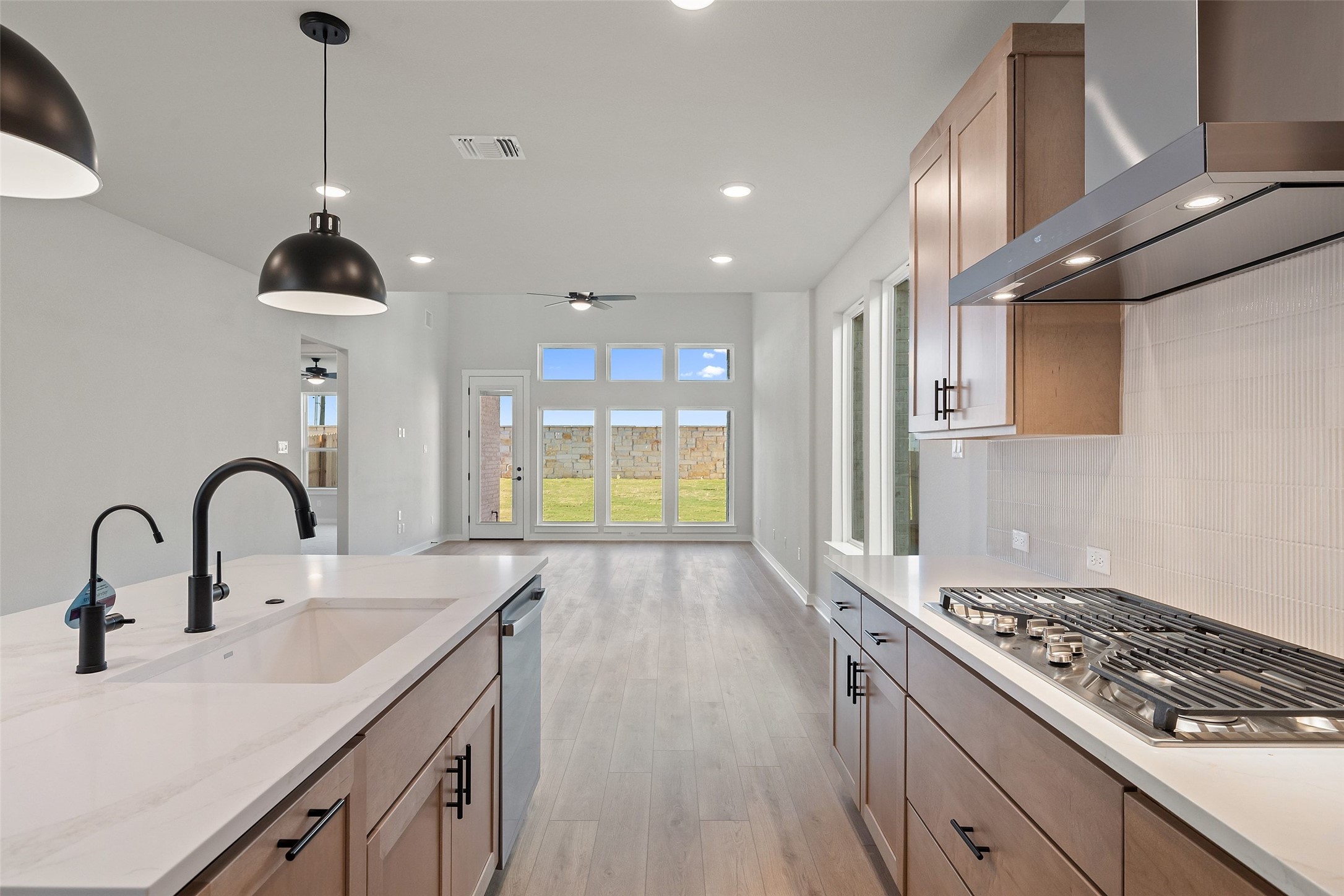 228 Brandywine Road Hutto, TX 78634 - Photo 14 of 40 a kitchen with stainless steel appliances a sink stove and refrigerator