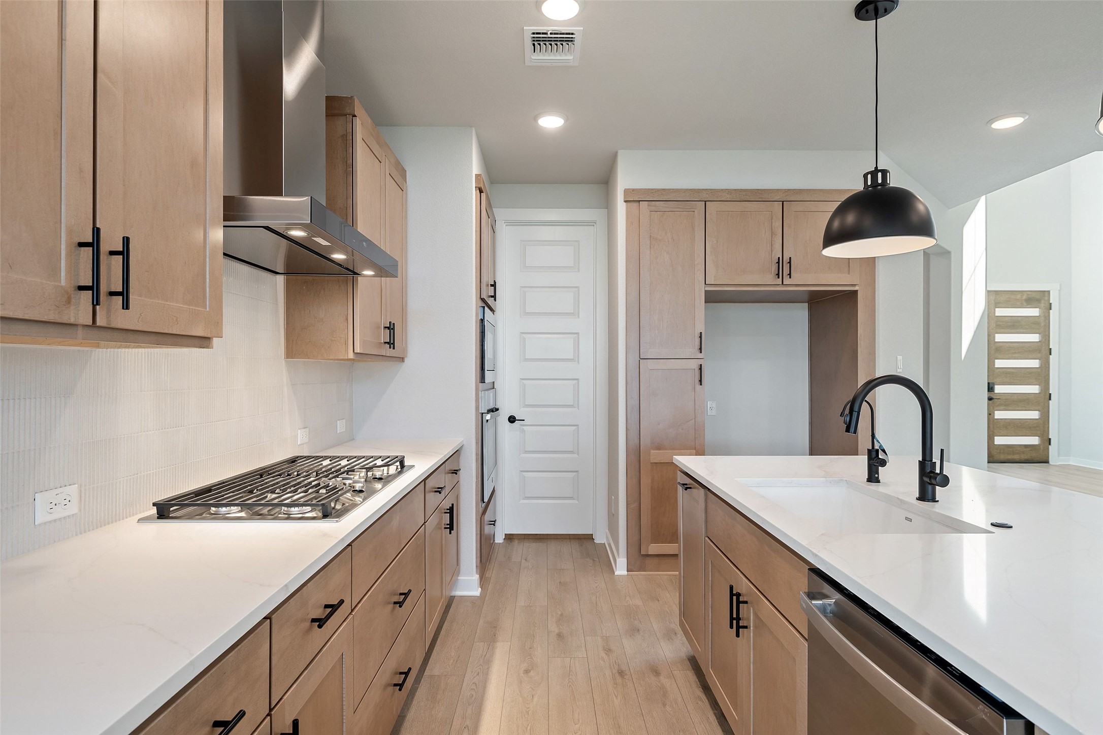 228 Brandywine Road Hutto, TX 78634 - Photo 15 of 40 a kitchen with stainless steel appliances a sink stove and refrigerator