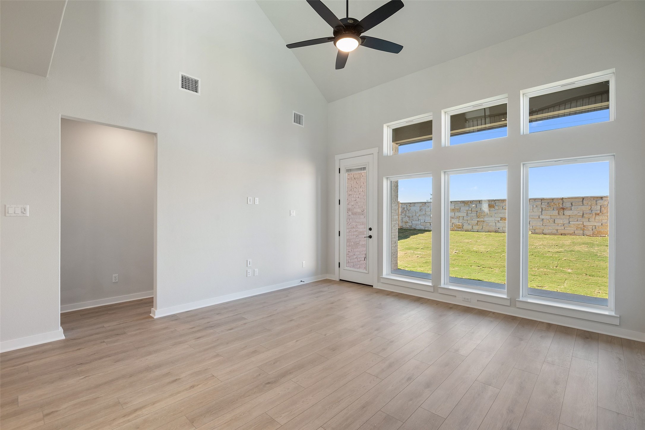228 Brandywine Road Hutto, TX 78634 - Photo 19 of 40 a view of an empty room with wooden floor and a window