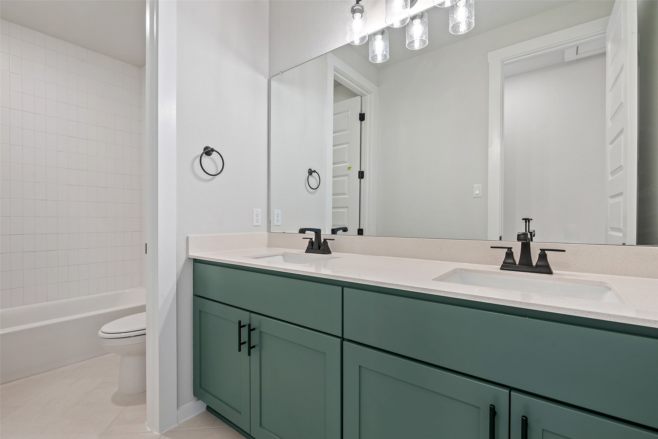 228 Brandywine Road Hutto, TX 78634 - Photo 35 of 40 a bathroom with a granite countertop sink a toilet and a mirror