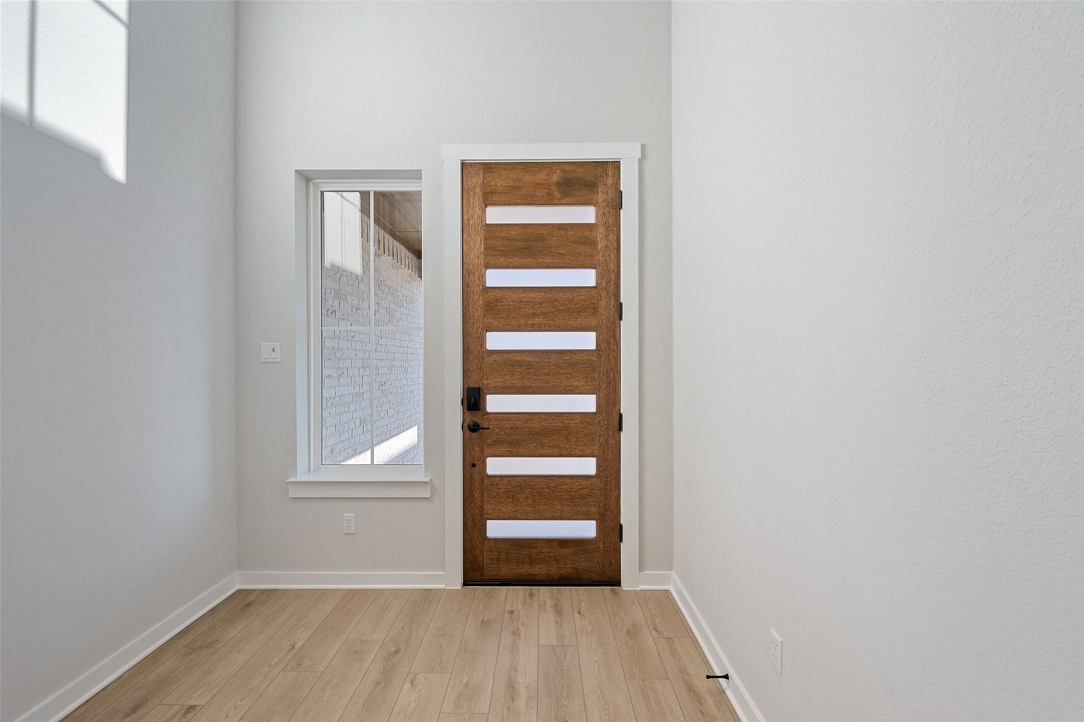 228 Brandywine Road Hutto, TX 78634 - Photo 6 of 40 a view of an empty room with wooden floor and a window