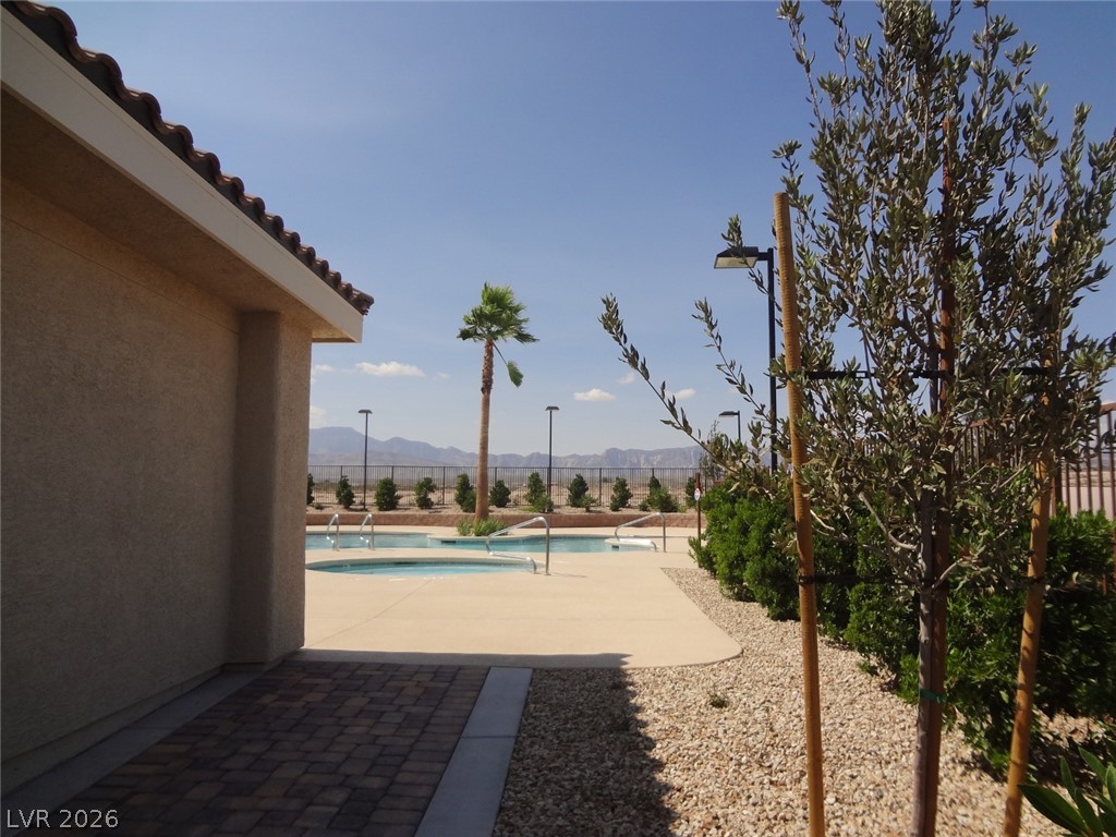 9453 Alma Ridge Avenue Las Vegas, NV 89178 - Photo 22 of 25 An inviting community pool with mountain vistas awaits, perfect for leisurely afternoons.