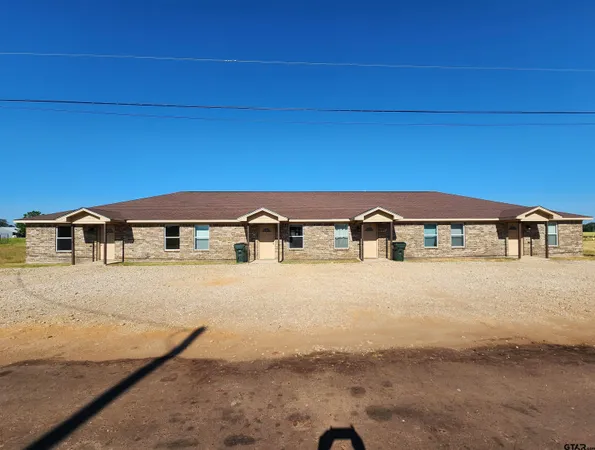 a front view of a house with yard
