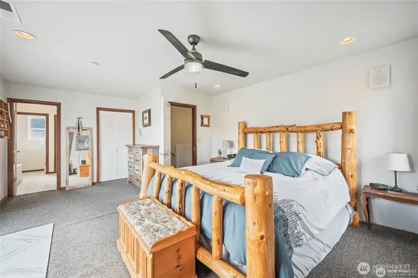 a bathroom with a tub a sink and a large mirror