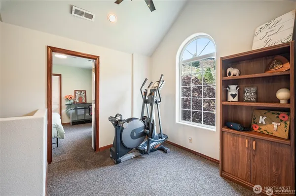 a bedroom with a bed and a dresser with racks