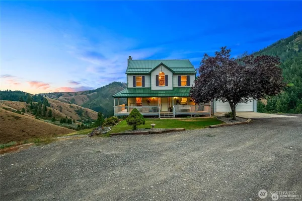 a view of balcony with chairs and wooden fence
